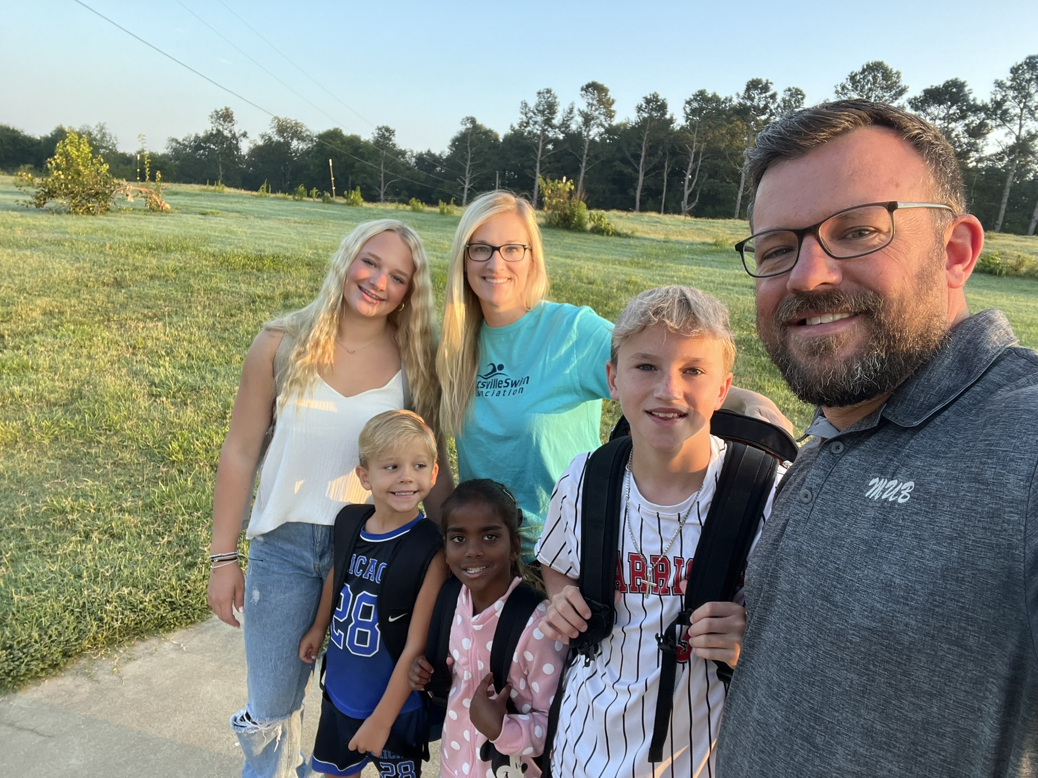 The picture is outside. From left to right, Carson, Brooke, Kai, and Chase. Holland and Navee are in front of the other four.